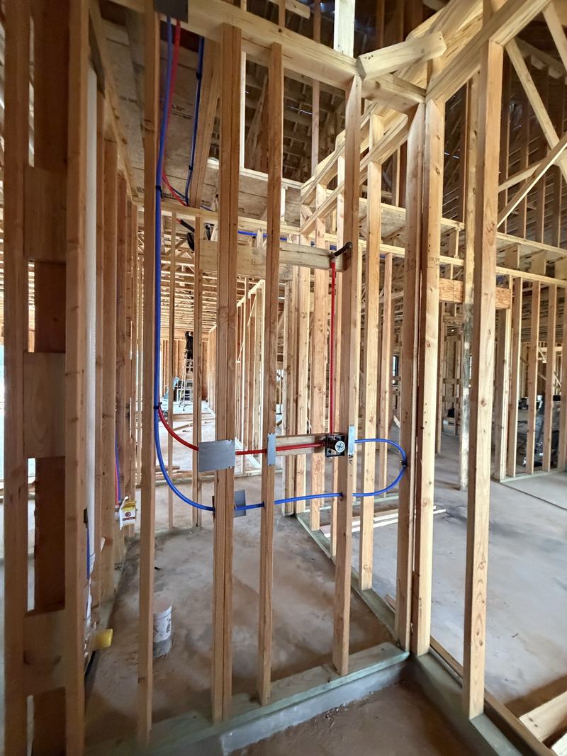 Uponor PEX-A hot and cold lines run through new construction framing